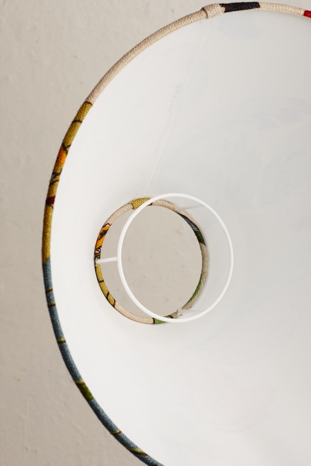 A duplex shade carrier ring inside a lampshade, seen from below