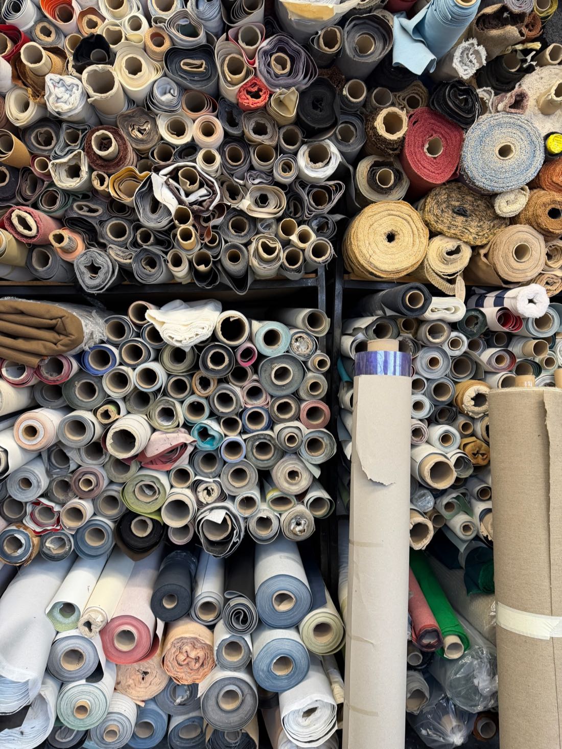 Racks of fabric rolls stacked from the floor to the ceiling